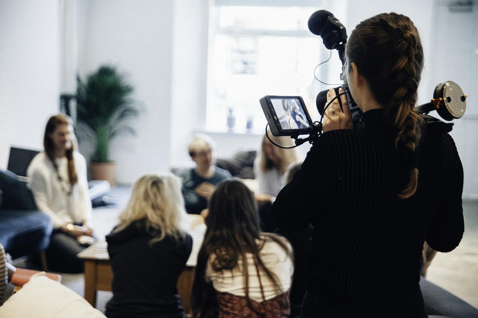 Filming av et møte i et lyst kontorlokale